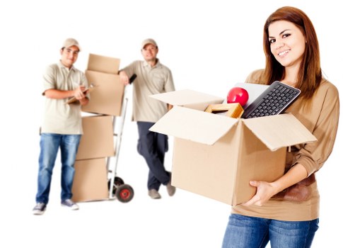 Local movers packing fragile household items with protective wrapping in Greenwich