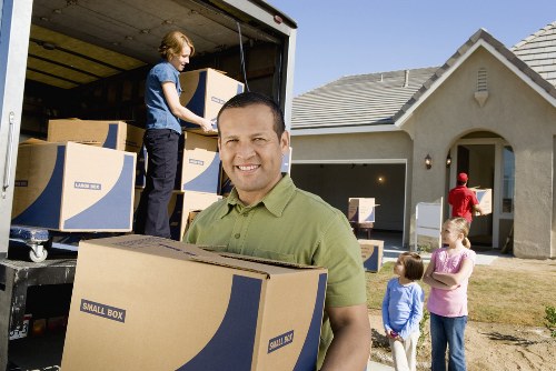 Movers Greenwich staff managing a moving job with customer obligations